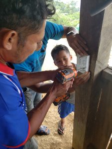 man Drilling while a Kid Watching